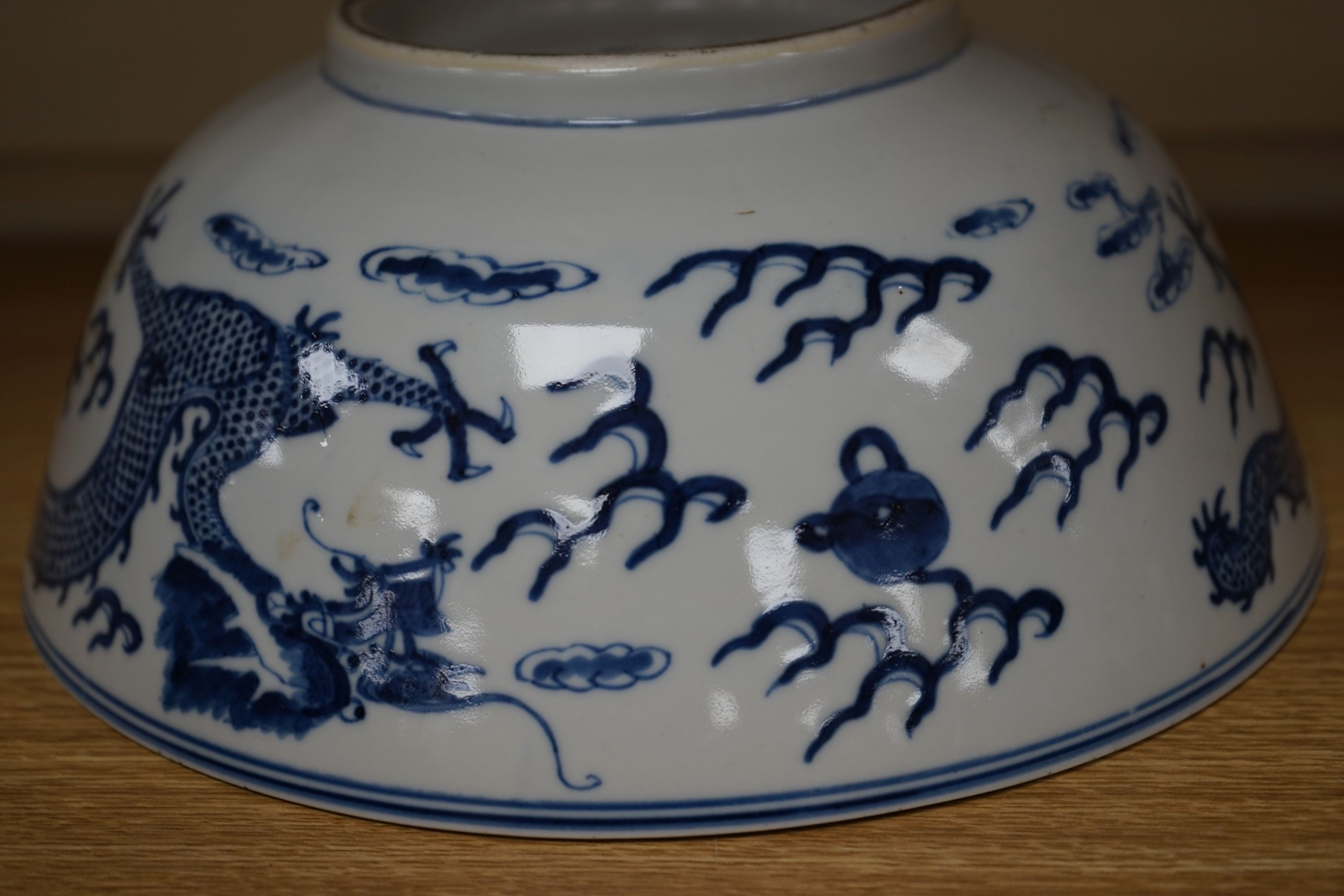 A Chinese blue and white ‘dragon’ bowl, Kangxi mark, late 19th century 25cm